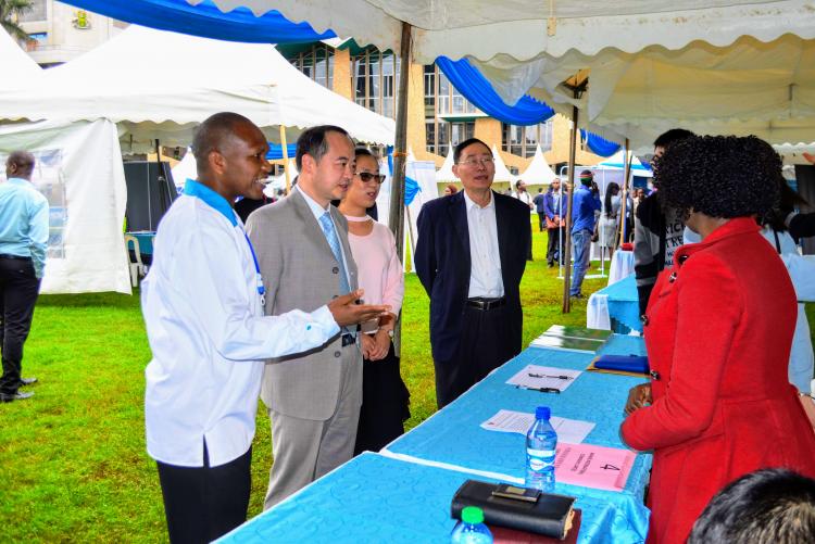 Mr. Kinyua engaging an exhibitor