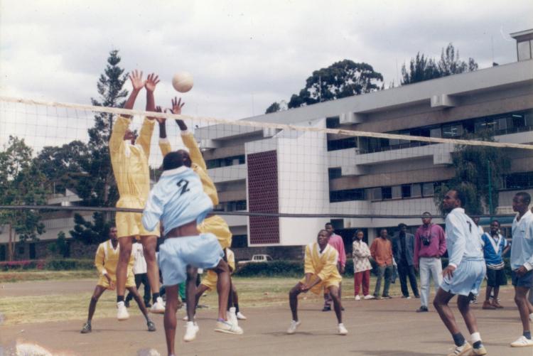 Male students playing volleyball at university grounds in 2000.