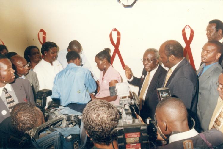 Miss Melida(lady at centre) receiving vaccination flanked by Minister for Public HealthHon. Sam Ongeri during trials of Aids vaccine launch at medical school KNH 2001.